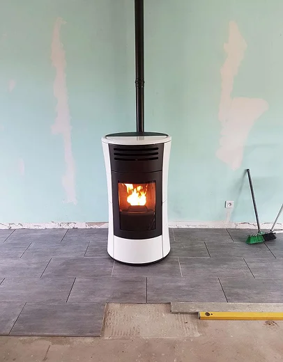 Poêle à granulés moderne blanc et noir avec feu, carrelage gris en cours d'installation à Saint-Pathus près de Meaux en Seine-et-Marne 77